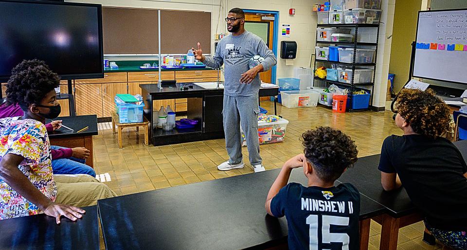 Mark James Jr. speaks with students in a classroom at The Webster School in West Augustine, where he volunteers, on Friday, Dec. 3, 2021. James,  a corrections officer for the St. Johns County Sheriff's Office, is a finalist for USA TODAY'S inaugural Best of Humankind awards.