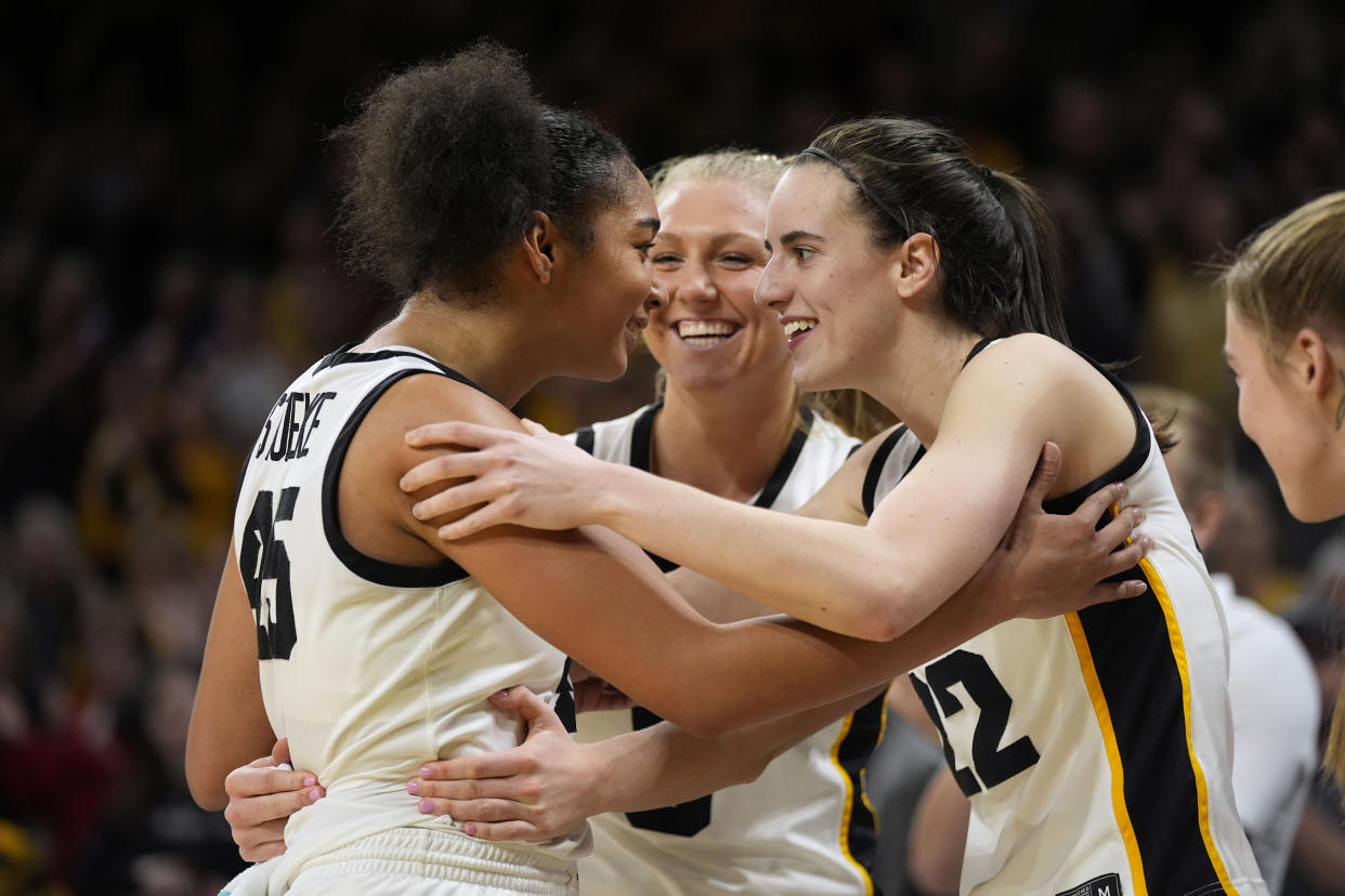 Iowa forward Hannah Stuelke (left) and guard Sydney Affolter (center) have thrived in bigger roles on the team this season with Caitlin Clark leading the way. (AP Photo/Charlie Neibergall)