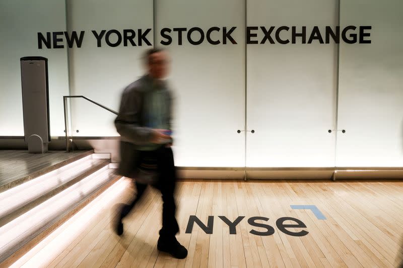 A trader walks on the trading floor of the NYSE in New York