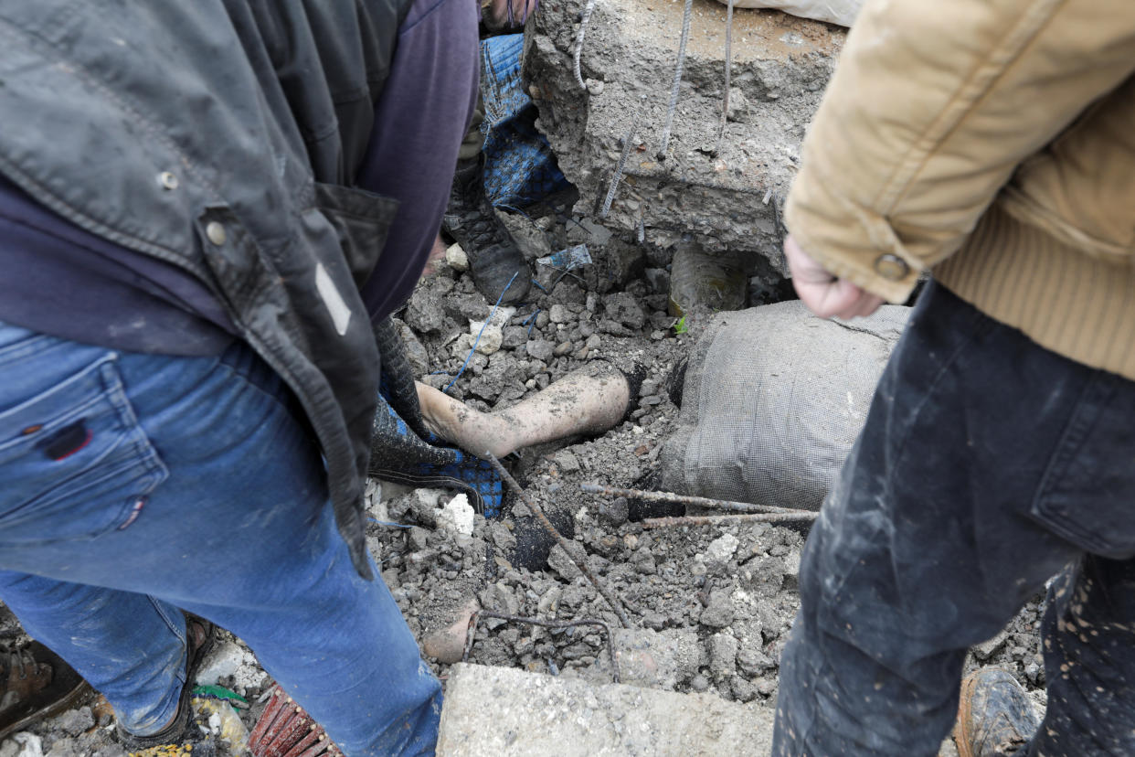 Rescuers search for survivors under the rubble.