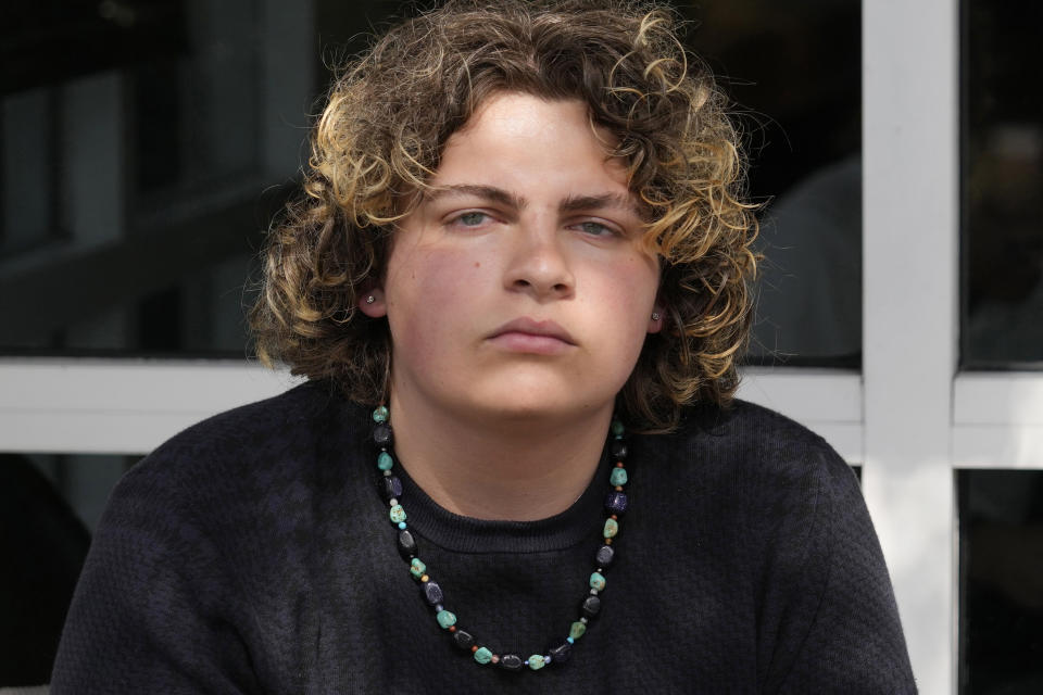 Jack Fitzgerald, a senior at J.P. Taravella High School who started the school's the Gender and Sexuality Alliance club, sits for a portrait in Lauderhill, Fla., on Wednesday, April 19, 2023. Jack came out to friends by accident at first. At a book club meeting he blurted out: “I don’t really like romance books unless they’re gay.” He hadn’t told anyone he was bisexual, but it came out easily in a place where he felt comfortable and safe. (AP Photo/Marta Lavandier)