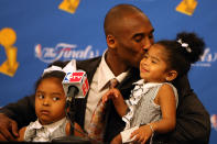 Kobe Bryant kisses daughter Gianna in a press conference after the Lakers' win over the Boston Celtics in Game Five of the 2008 NBA Finals on June 15, 2008 at Staples Center in Los Angeles, California. (Photo by Jed Jacobsohn/Getty Images)