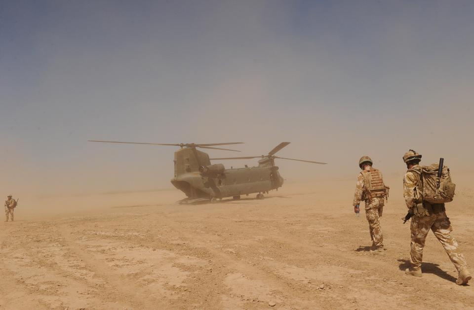 British soldiers walk to a military helicopter near the Pimon military camp in Nad-e Ali district of Helmand province, Afghanistan  (AFP via Getty Images)