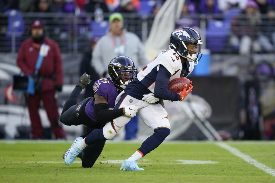 Baltimore Ravens cornerback Kevon Seymour (25) tackles Denver Broncos wide receiver Montrell Washington (12) on a punt return in the second half of an NFL football game, Sunday, Dec. 4, 2022, in Baltimore. (AP Photo/Patrick Semansky)