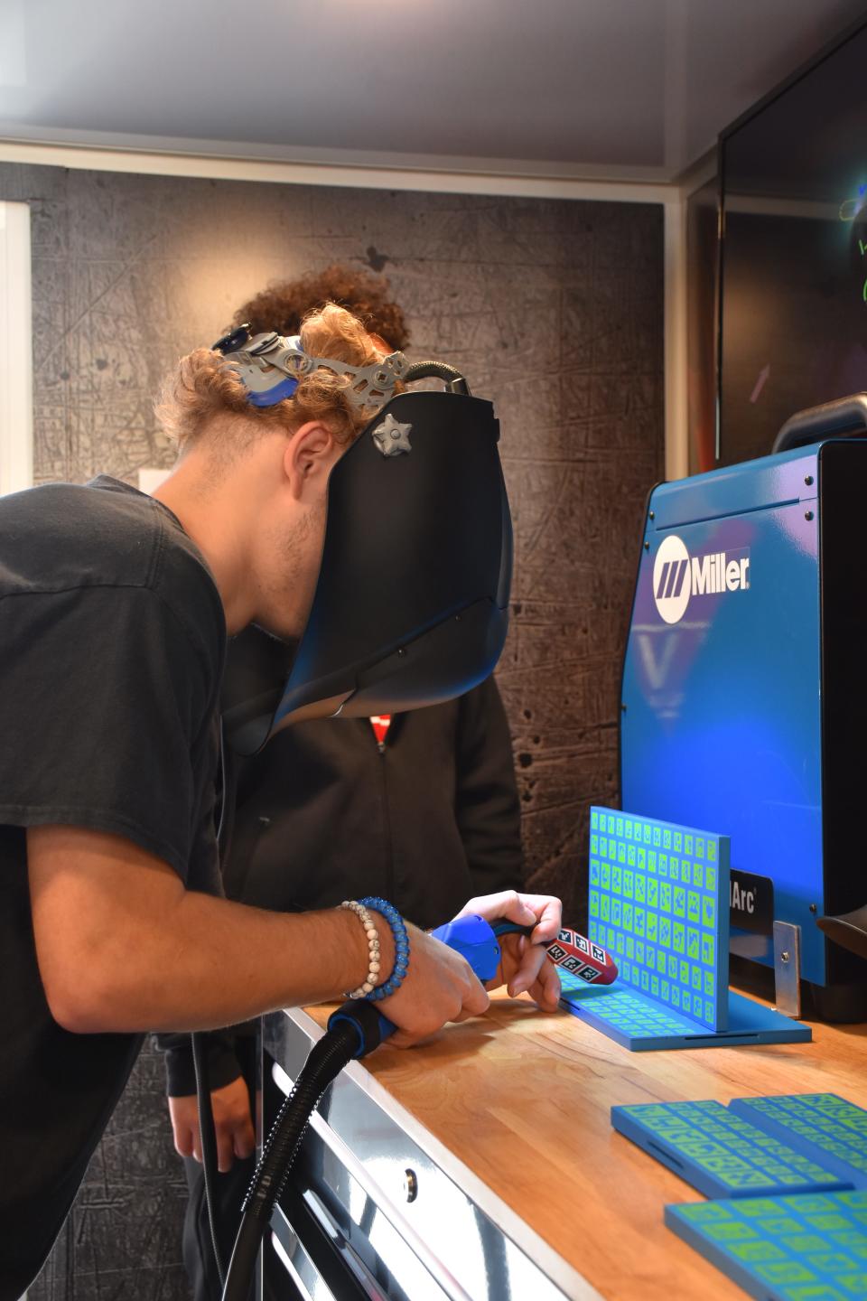 A student uses virtual reality to practice welding.