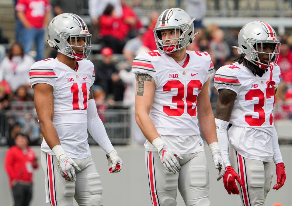 Ohio State linebackers C.J. Hicks and Gabe Powers line up next to safety Kye Stokes during 2022's spring game.