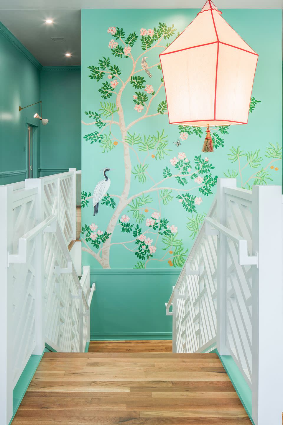 bright teal tropical mural near stairwell