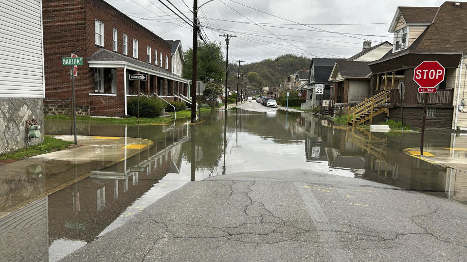 The intersection at Dewey and Martha Streets in Etna, Pa. near Pittsburgh, is closed, Friday, April 12, 2024 after high water rolled over a creek Thursday night in a flash flood. (Mary Ann Thomas/Pittsburgh Post-Gazette via AP)