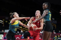 Belgium's Julie Allemand, center, drives to the basket between Australia's Katie Ebzery (10) and Ezi Magbegor, right, during a women's basketball preliminary round game at the 2020 Summer Olympics, Tuesday, July 27, 2021, in Saitama, Japan. (AP Photo/Charlie Neibergall)