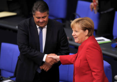 German Chancellor Angela Merkel and German Economy Minister Sigmar Gabriel arrive for a meeting at the lower house of parliament Bundestag on 2017 budget in Berlin, Germany, September 7, 2016. REUTERS/Stefanie Loos