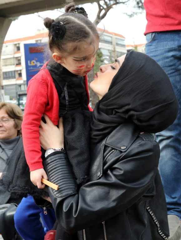 A Lebanese woman kisses her daughter as protesters gather outside the Supreme Shiite Council in Beiruit to demand a change in child custody laws that favour fathers over mothers in divorce cases