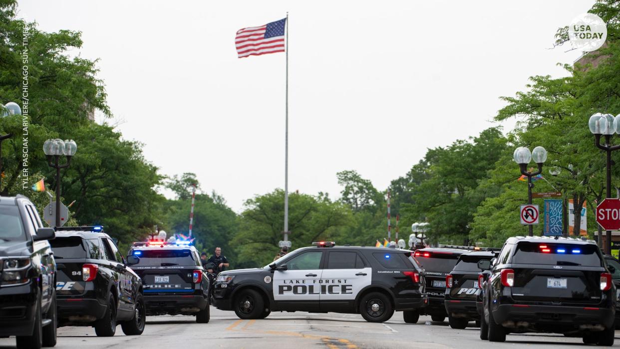 Local, state and federal police work the scene of a mass shooting at a Fourth of July parade in Highland Park, Ill.