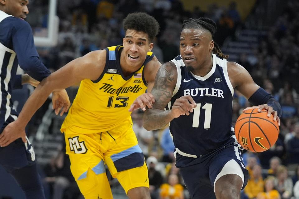 Butler's Jahmyl Telfort gets past Marquette's Oso Ighodaro during the second half of an NCAA college basketball game Wednesday, Jan. 10, 2024, in Milwaukee. Butler won 69-62. (AP Photo/Morry Gash)