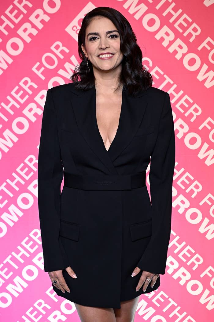 Cecily in a tailored black blazer dress posing on the red carpet