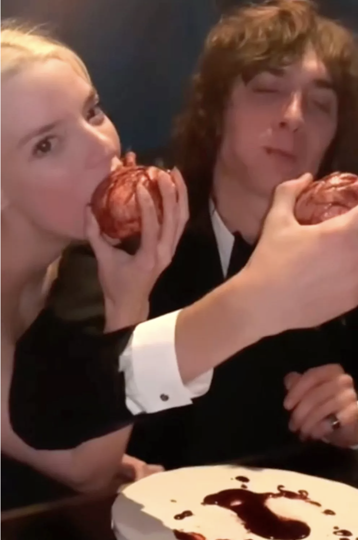 a couple of women eating donuts