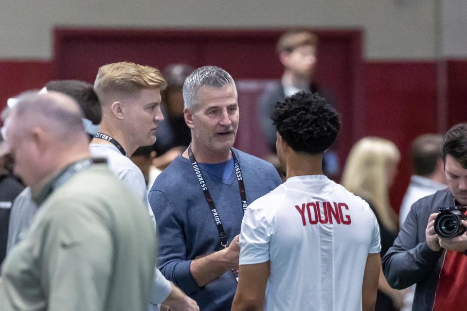 Carolina Panthers head football coach Frank Reich talks with former Alabama quarterback Bryce Young at Alabama's NFL pro day.