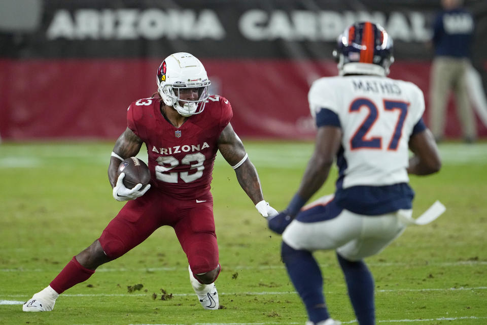 Arizona Cardinals running back Corey Clement (23) runs against Denver Broncos cornerback Damarri Mathis (27) during the first half of an NFL preseason football game in Glendale, Ariz., Friday, Aug. 11, 2023. (AP Photo/Matt York)