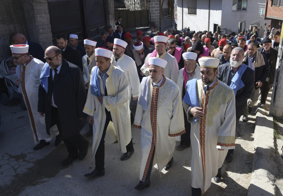 Imams lead the procession during circumcision ceremony in the village of Ribnovo, Bulgaria, Sunday, April 11, 2021. Despite the dangers associated with COVID-19 and government calls to avoid large gatherings, Hundreds of people flocked to the tiny village of Ribnovo in southwestern Bulgaria for a four-day festival of feasting, music and the ritual of circumcision which is considered by Muslims a religious duty and essential part of a man's identity. (AP Photo/Jordan Simeonov)