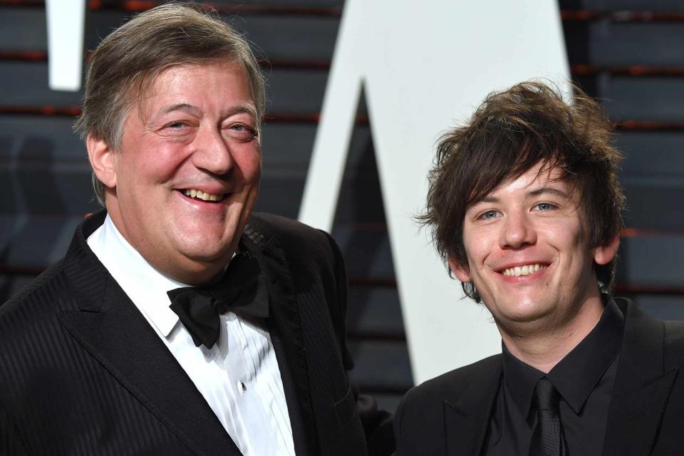 <p>Anthony Harvey/Getty</p> Stephen Fry and Elliott Spencer in 2017