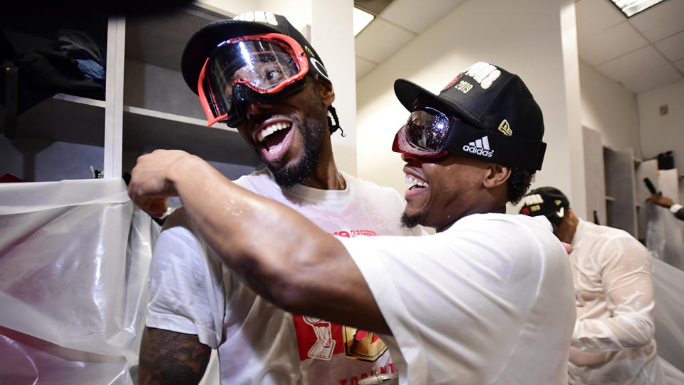 Leonard, left, and Lowry celebrate in the locker room. THE CANADIAN PRESS/Frank Gunn