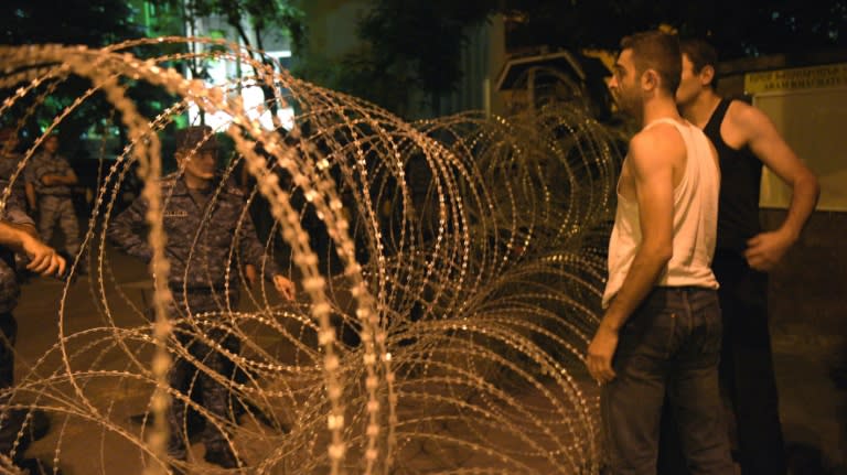 Armenian police block a street to Erebuni police station seized by gunmen - supporters of fringe jailed opposition leader Zhirair Sefilyan - in Yerevan early on July 31, 2016