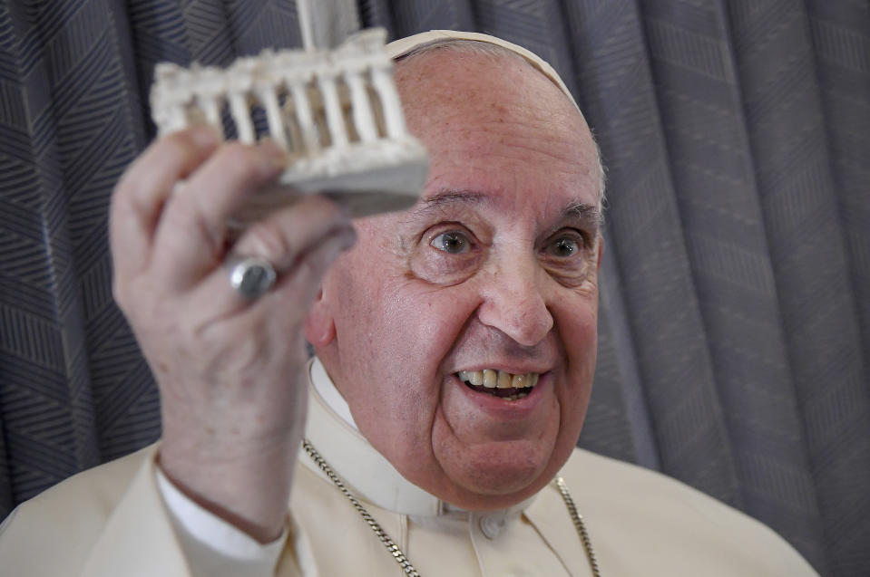 Pope Francis greets the journalists onboard the papal plane on the occasion of his five-day pastoral visit to Cyprus and Greece, Monday, Dec. 6, 2021. Francis' five-day trip to Cyprus and Greece has been dominated by the migrant issue and Francis' call for European countries to stop building walls, stoking fears and shutting out "those in greater need who knock at our door." (Alessandro Di Meo/Pool photo via AP)