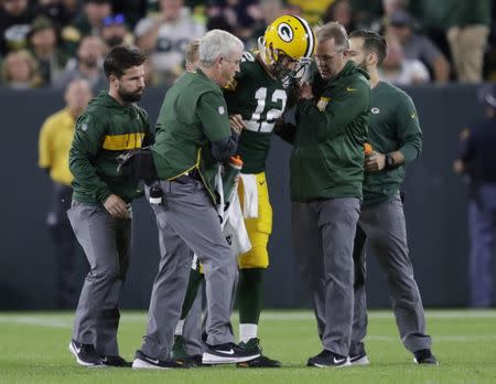Sep 9, 2018; Green Bay, WI, USA; Green Bay Packers quarterback Aaron Rodgers (12) is helped off the field after getting injured during the second quarter against the Chicago Bears at Lambeau Field. Mandatory Credit: Dan Powers/Appleton Post-Crescent via USA TODAY NETWORK