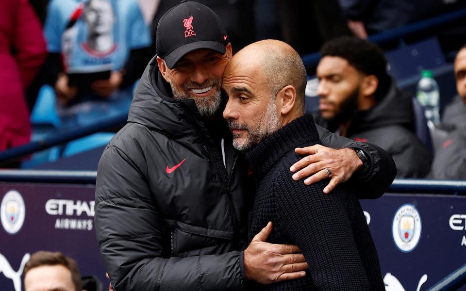 Manchester City manager Pep Guardiola hugs Liverpool manager Jurgen Klopp before the match