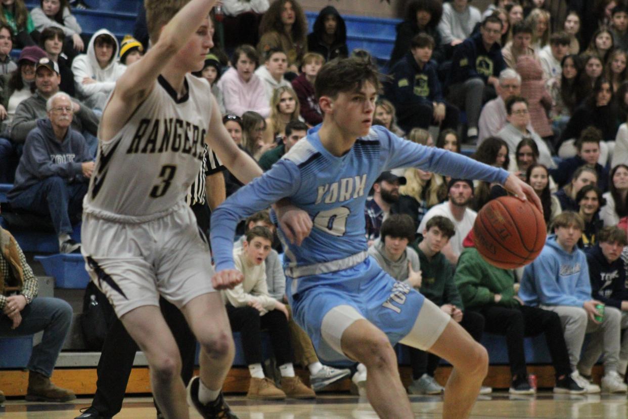 York High School junior guard Connor Roberge drives to the rim against Traip Academy's Ben Hawkes during Monday's rivalry game in Kittery, Maine.