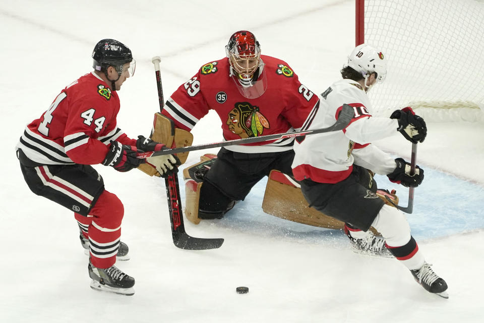 Ottawa Senators' Alex Formenton (10) is unable to get a rebound off his shot on goal as Chicago Blackhawks' Calvin de Haan (44) and goaltender Marc-Andre Fleury defend during the first period of an NHL hockey game Monday, Nov. 1, 2021, in Chicago. (AP Photo/Charles Rex Arbogast)