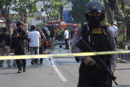 Police stand guard near the site of a blast at the Pentecost Church Central Surabaya (GPPS), in Surabaya, East Java, Indonesia May 13, 2018 in this photo taken by Antara Foto. Antara Foto/Moch Asim / via REUTERS