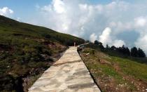 Misty mountains tower over Chopta. After breakfast, we begin the 4 km-climb to Tungnath. The paved trail winds through a tract of dense forest interspersed with alpine meadows, known as bugyals in the Garhwali dialect. Ahead of us, walking in leather slippers and a thin saffron robe was a sadhu. How he defended himself against the punishing elements we do not know. But then again, centuries ago a young saint from Kerala, Adi Sankara, walked these very paths.