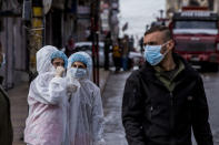 Medical workers oversee the disinfection of the streets to prevent the spread of coronavirus in Qamishli, Syria, Tuesday, March 24, 2020. (AP Photo/Baderkhan Ahmad)