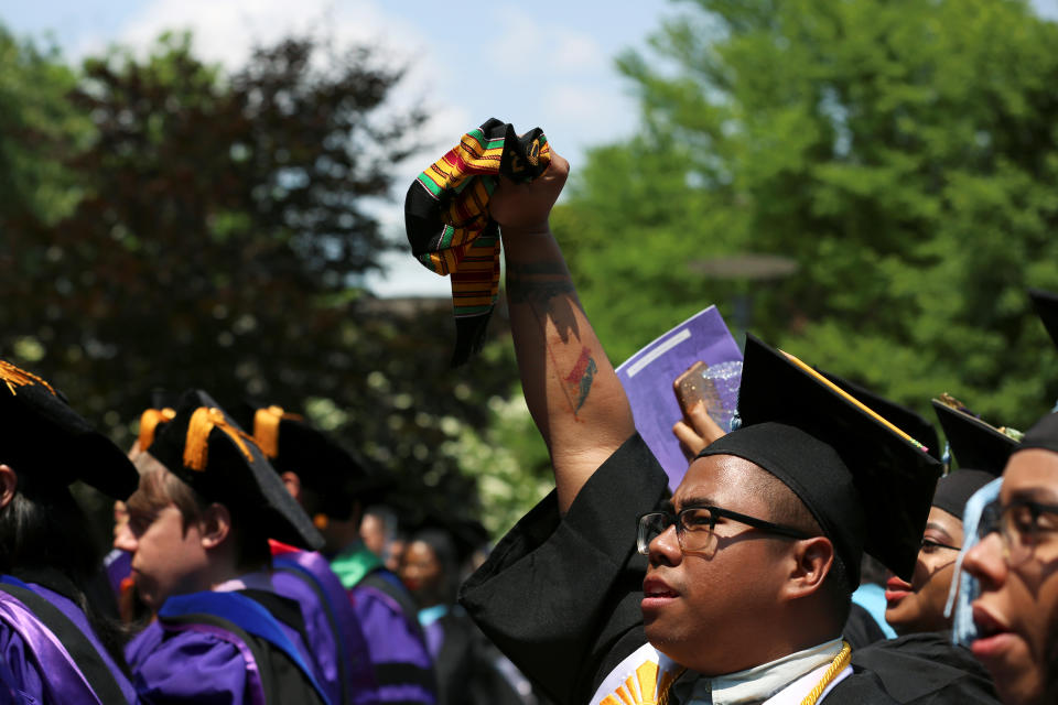 A graduate throws his fist in the air after congressman John Robert Lewis, 2019 honorarium of The City College of New York, speaks at the commencement ceremony in Manhattan on May 31, 2019. REUTERS/Gabriela Bhaskar