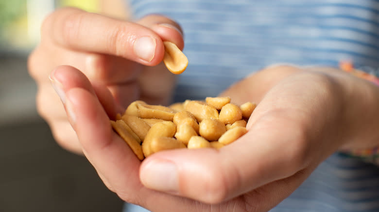 Man snacking on peanuts