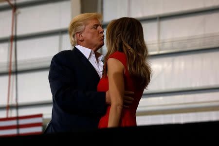 U.S. President Donald Trump kisses his wife Melania during a "Make America Great Again" rally at Orlando Melbourne International Airport in Melbourne, Florida, U.S. February 18, 2017. REUTERS/Kevin Lamarque