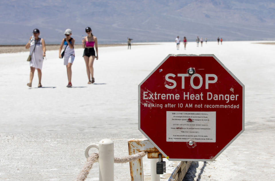 FILE - A stop sign warns tourists of extreme heat at Badwater Basin, Monday, July 8, 2024, in Death Valley National Park, Calif. A man from Belgium who suffered third-degree burns on his feet at the sand dunes in California's Death Valley National Park was rushed to the hospital over the weekend, park rangers said Thursday, July 25, 2024. (Daniel Jacobi II/Las Vegas Review-Journal via AP)