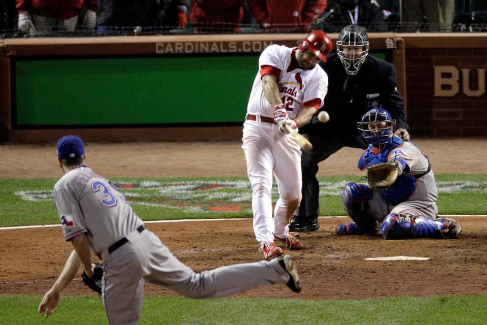 ST LOUIS, MO - OCTOBER 27: Lance Berkman #12 of the St. Louis Cardinals hits an RBI single to tie the game in the 10th inning off of Scott Feldman #39 of the Texas Rangers during Game Six of the MLB World Series at Busch Stadium on October 27, 2011 in St Louis, Missouri. (Photo by Rob Carr/Getty Images)