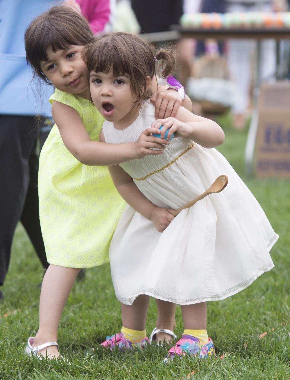Children participate in an Easter egg roll race during the 139th White House Easter Egg Roll.