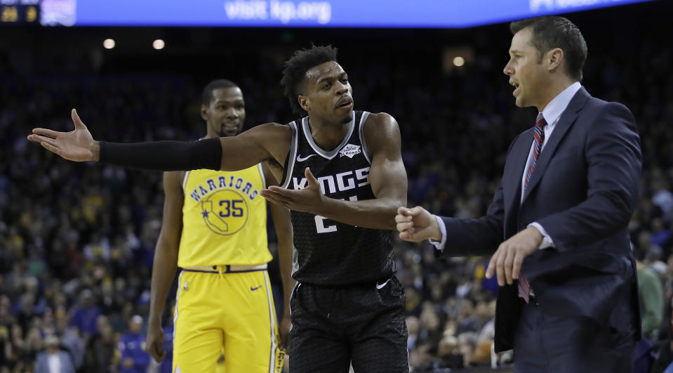 Buddy Hield argues with head coach Dave Joerger after a made a 3-pointer late in the fourth quarter against the Warriors on Thursday. Later, Hield missed a potentially game-tying field goal after passing on a 3-point attempt. (AP Photo/Ben Margot)