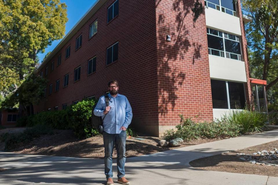 Chris Lambert, an Orcutt musician and recording engineer, poses Thursday, April 15, 2021, in front of Muir Hall dormitory at Cal Poly in San Luis Obispo. Lambert started a podcast to document the 1996 disappearance of Kristin Smart, who was a college student at Cal Poly and lived in Muir Hall when she disappeared. 