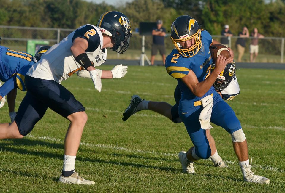 Ryin Ruddy of Whiteford (left) finishes off the tackle of Ida quarterback Nathan Miller of Ida after Kolby Masserant made the initial hit Thursday. Whiteford won 32-18.