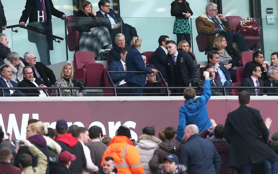 The West Ham crowd turns on the directors' box, including co-owner David Sullivan, centre, with glasses, and vice-chairman Karren Brady, top left - Offside