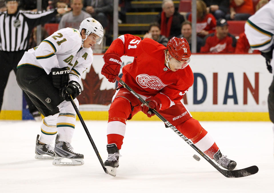 DETROIT, MI - FEBRUARY 14: Valtteri Filppula #51 of the Detroit Red Wings tries to control the puck in front of Loui Eriksson #21 of the Dallas Stars at Joe Louis Arena on February 14, 2012 in Detroit, Michigan. (Photo by Gregory Shamus/Getty Images)