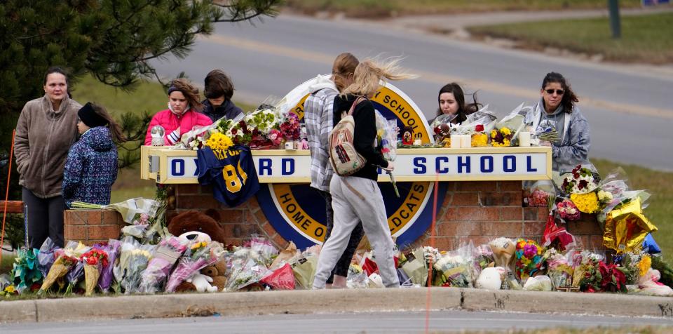 The cold winds did not discourage youth and community members from bringing flowers and praying at a makeshift memorial at Oxford High School on Dec. 2, 2021, after 4 students were shot dead and several injured when Ethan Crumbley allegedly open fire on the students and teachers at the school earlier this week.