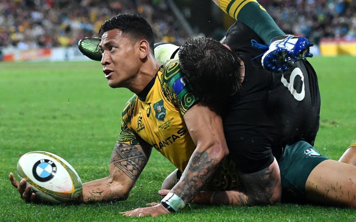 Israel Folau celebrates his first-half try in Brisbane - AAP