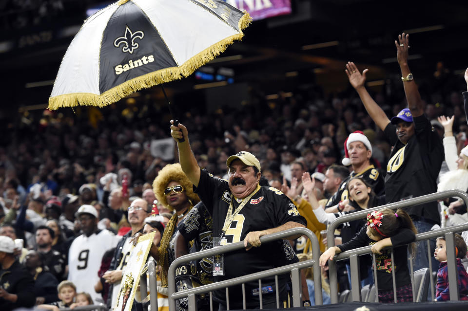 New Orleans Saints fans celebrate in the second half of a win over the Falcons in Week 16. (AP)