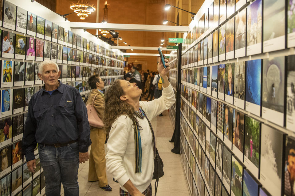 A woman takes a photo of her entries selected to be the exhibit. (Photo: Gordon Donovan/Yahoo News)