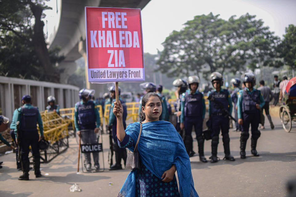 A woman holds a placard as supporters of Bangladesh Nationalist Party (BNP) form a human chain marking International Human Rights Day in Dhaka, Bangladesh, Sunday, Dec.10, 2023. The opposition allege that thousands of their activists have been detained by security agencies ahead of the country's general election on Jan. 7. The BNP, led by former Prime Minister Khaleda Zia, is boycotting the election leaving voters in the South Asian nation of 166 million with little choice but to re-elect Prime Minister Sheikh Hasina's Awami League for a fourth consecutive term. (AP Photo/ Mahmud Hossain Opu)