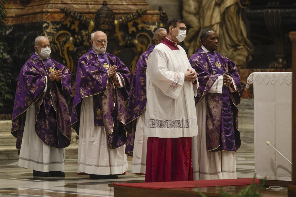 Cardinal Antoine Kambanda, right, attends a Mass celebrated by Pope Francis the day after the pontiff raised 13 new cardinals to the highest rank in the Catholic hierarchy, at St. Peter's Basilica, Sunday, Nov. 29, 2020. (AP Photo/Gregorio Borgia, Pool)
